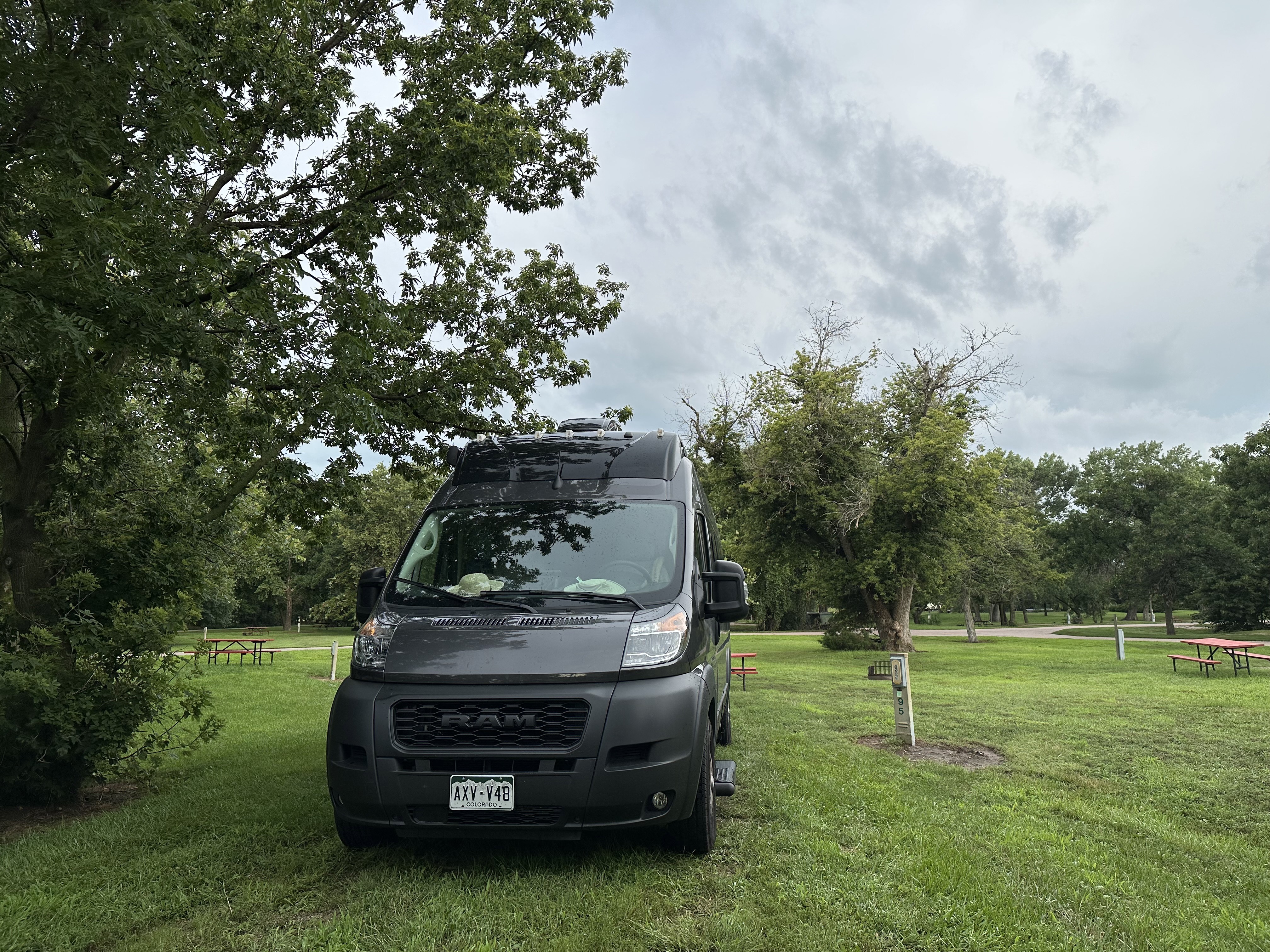 Vandy Patinkin parked on a grassy site next to a tree